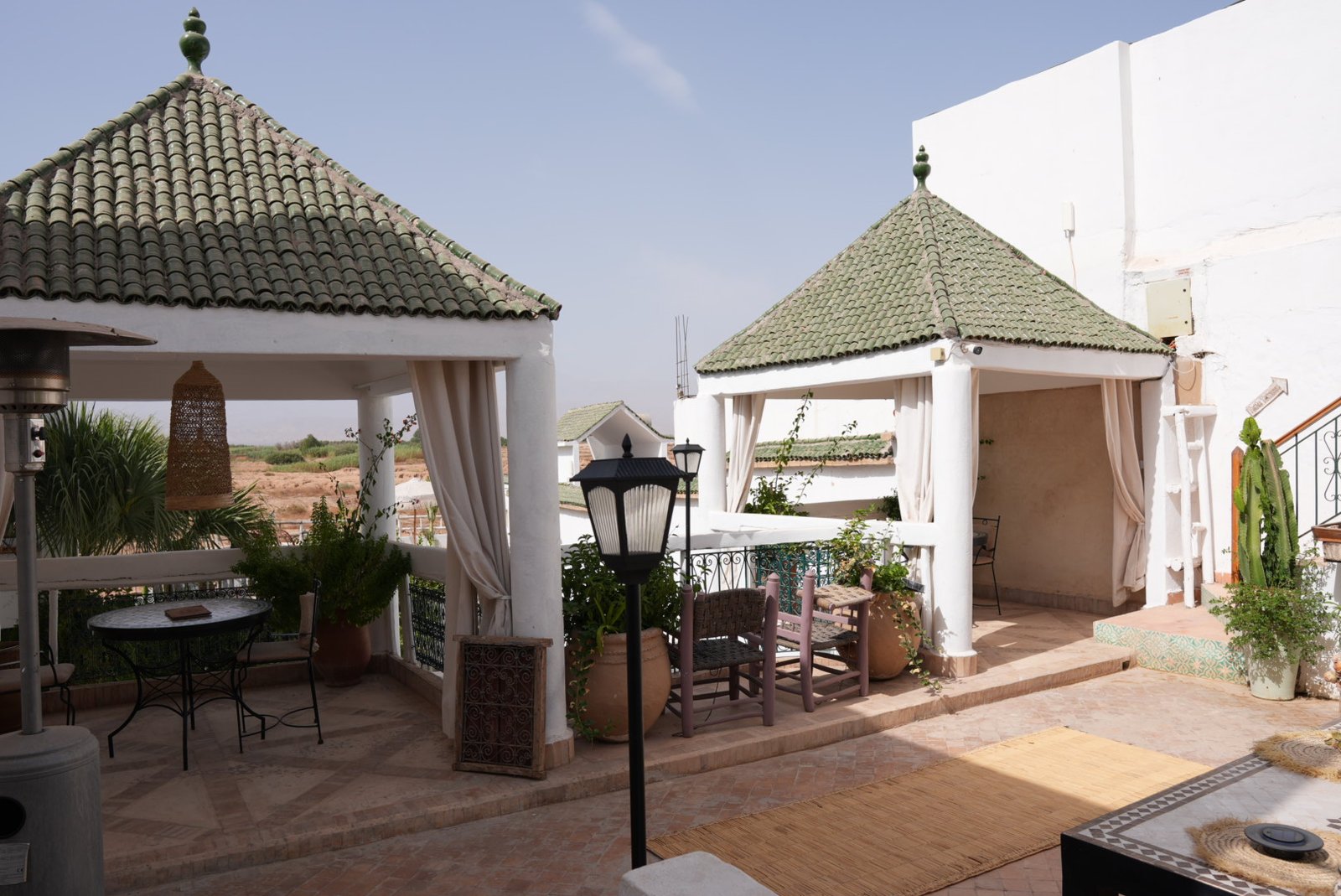 Rooftop gazebos with rugs, lanterns and a mosaic table